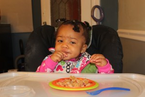 Quinn eating her organic waffles and strawberries