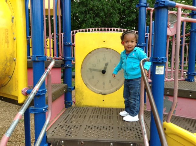 Quinn Playing with the Clock at the Park