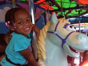 Quinn on her favorite ride: the carousel (or horsey ride as she likes to call it)